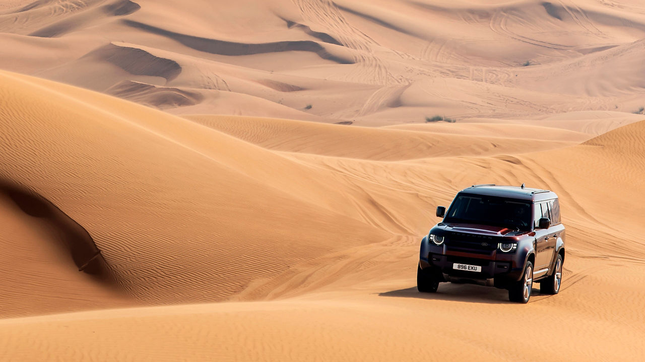 Defender driving in the desert