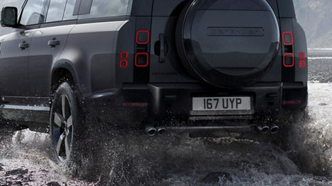 Defender is off roading in the mud of the river