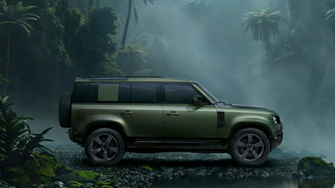 Defender parked in forest
