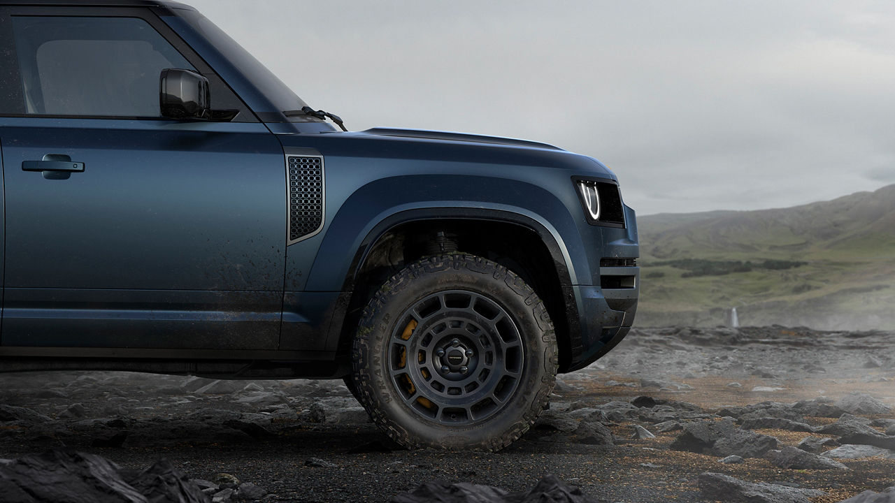Defender side view on mountain road