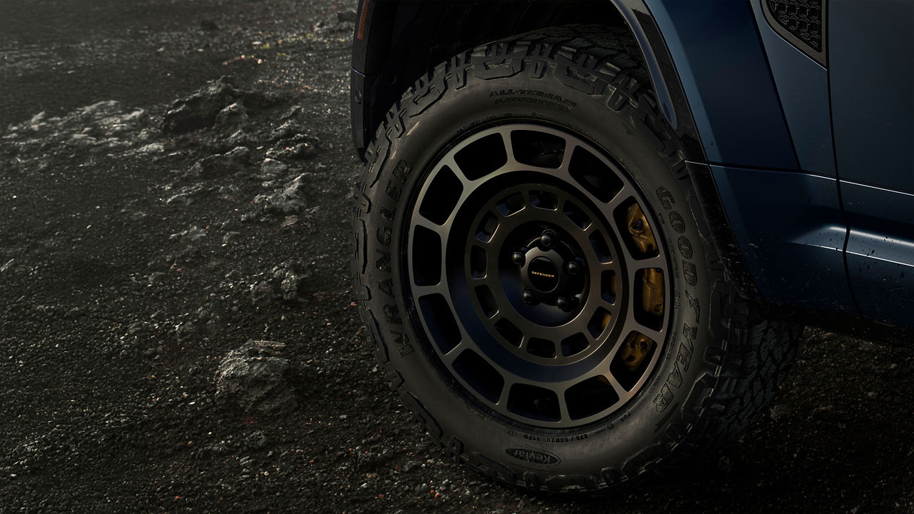Close-up of an Defender wheel on rough terrain.
