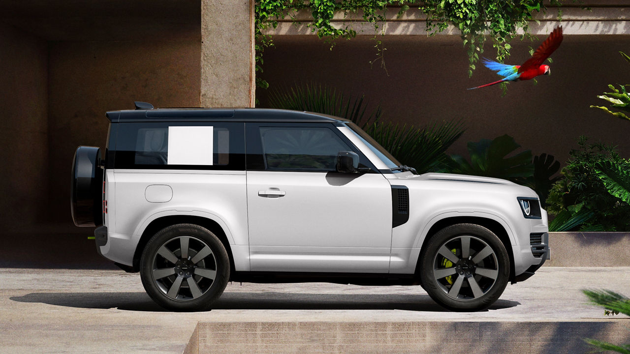 Defender parked in lush greenery and a shaded recessed space