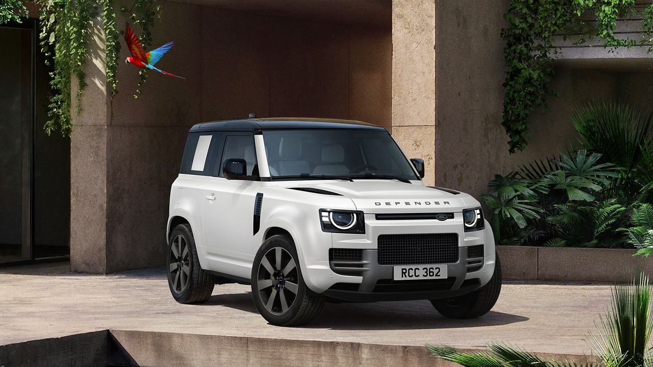 Defender parked in lush greenery and a shaded recessed space