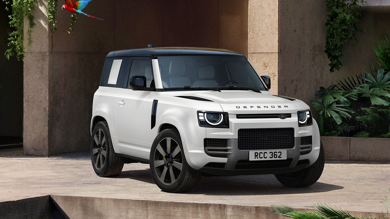 Defender parked in lush greenery and a shaded recessed space