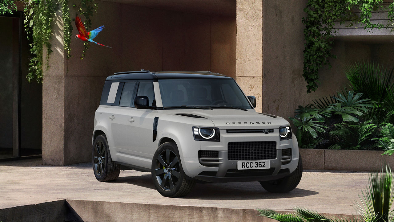 Defender parked in lush greenery and a shaded recessed space
