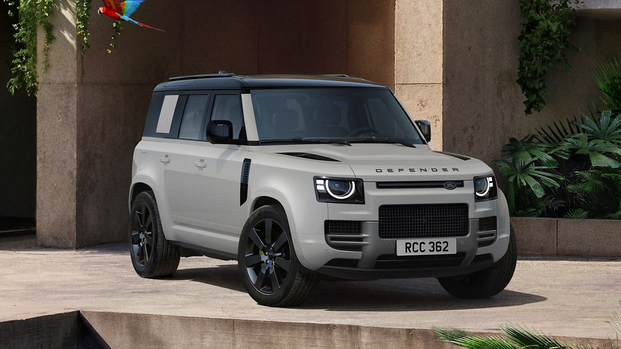 Defender parked in lush greenery and a shaded recessed space