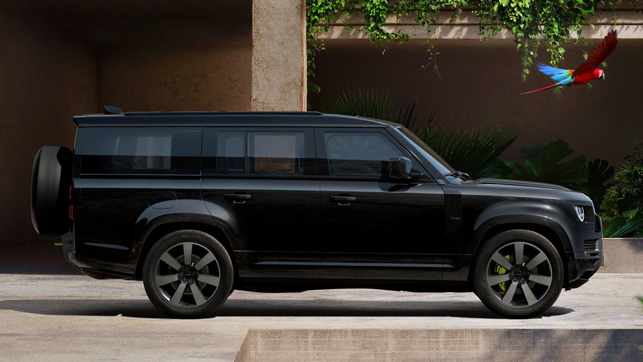 Defender parked in lush greenery and a shaded recessed space