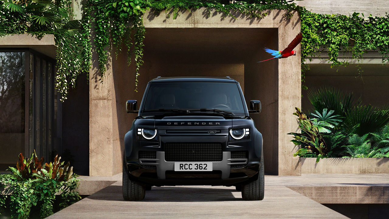 Defender parked in lush greenery and a shaded recessed space