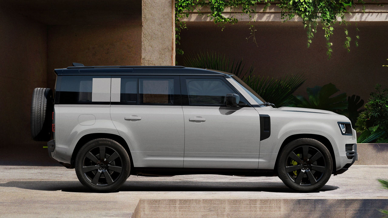 Defender parked in lush greenery and a shaded recessed space