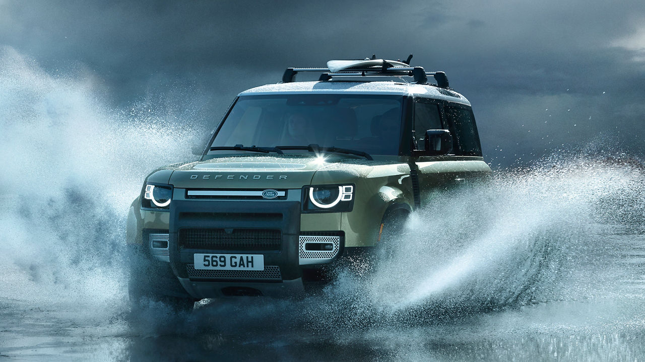 Man is Driving Defender At High Speed On seawater