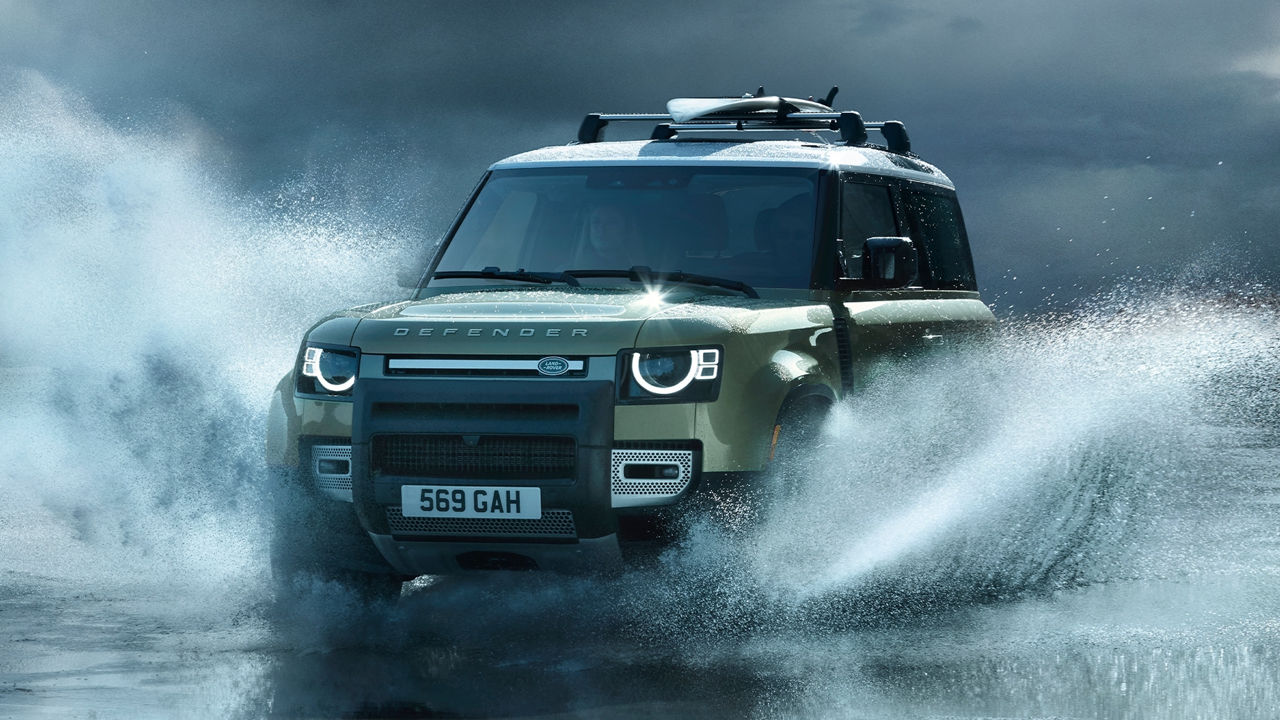 Man is Driving Defender At High Speed On seawater