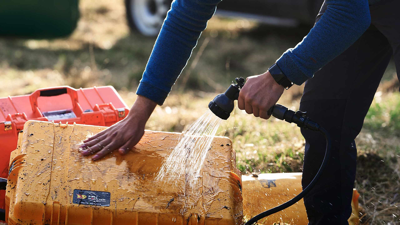 Man with Portable Rinse System, cleaning boxes