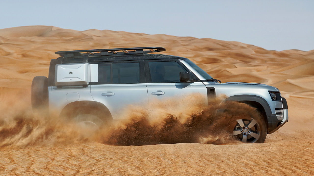 Defender drifting in desert 