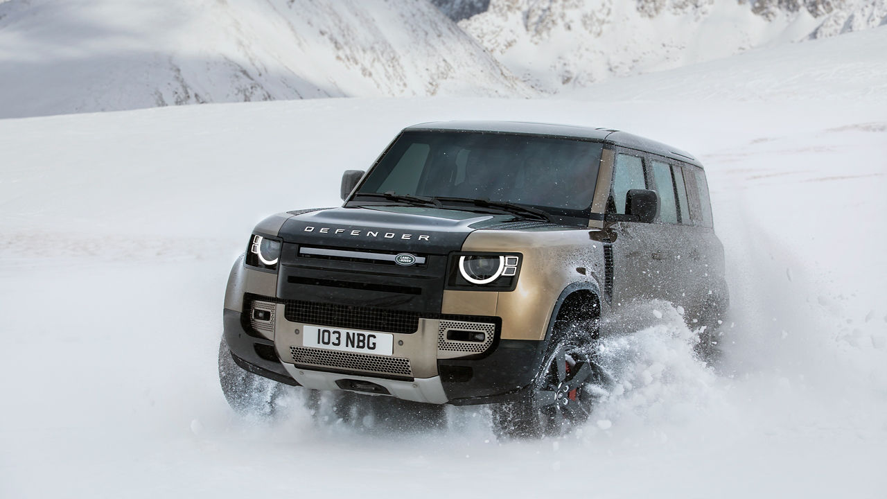 Defender Driving Through A Road Covered In Ice