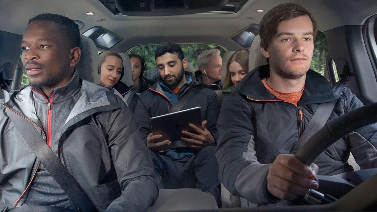 Group of people sitting in a Range Rover Defender