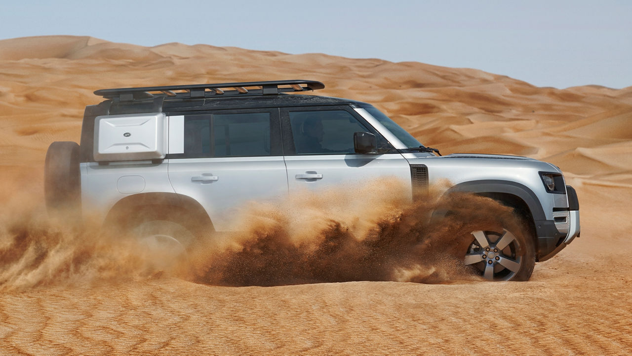 Land Rover Defender driving in the desert