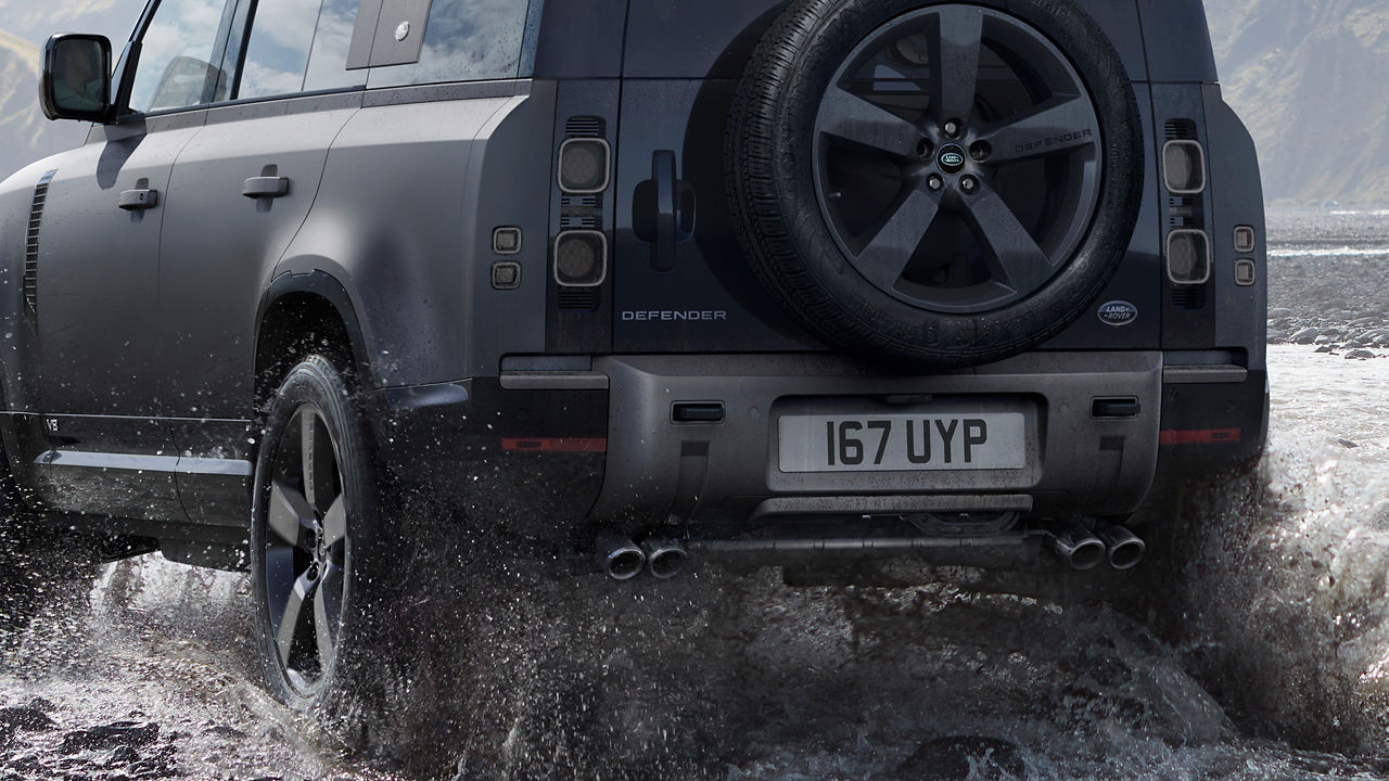 Defender is off roading in the mud of the river