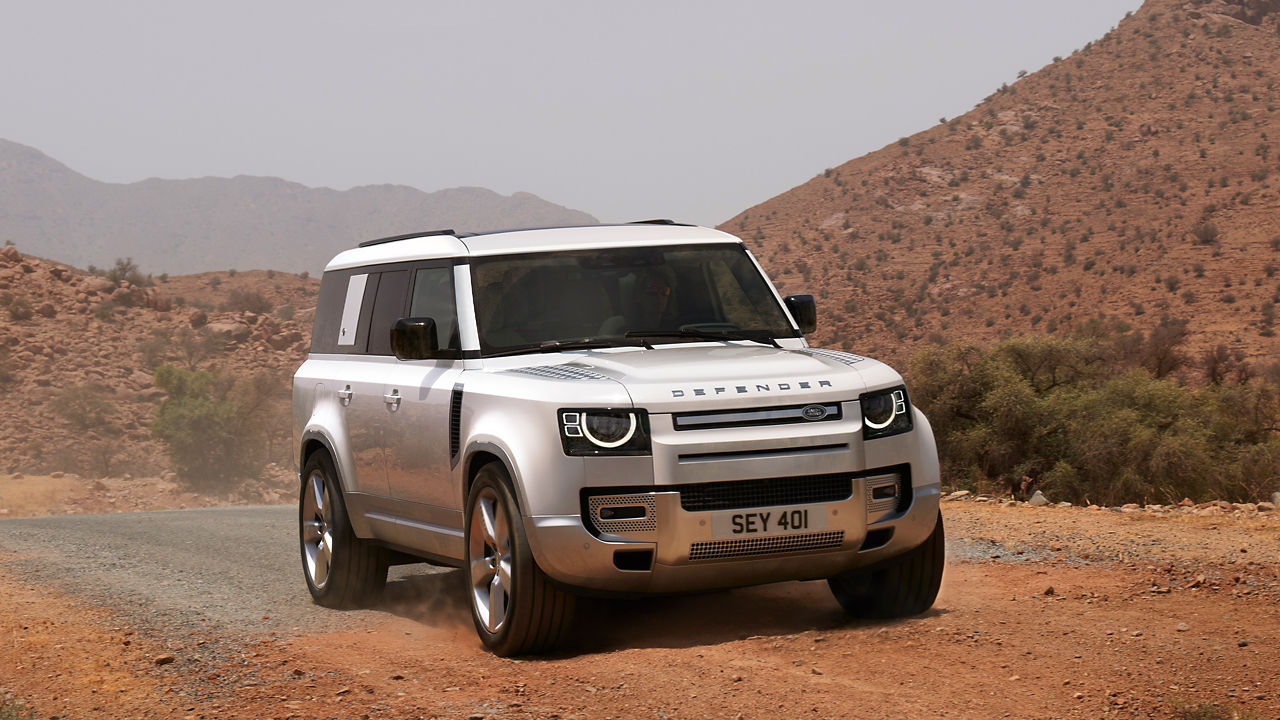 Defender Driving On Mountain Runway Road