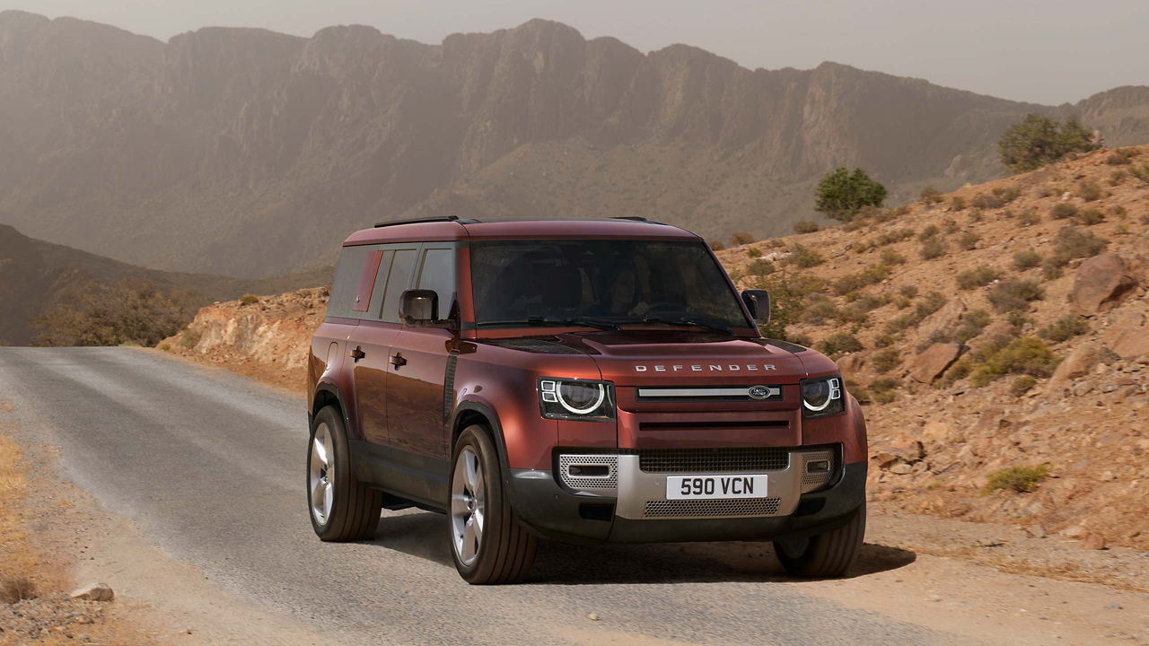 Defender Driving On Mountain Runway Road