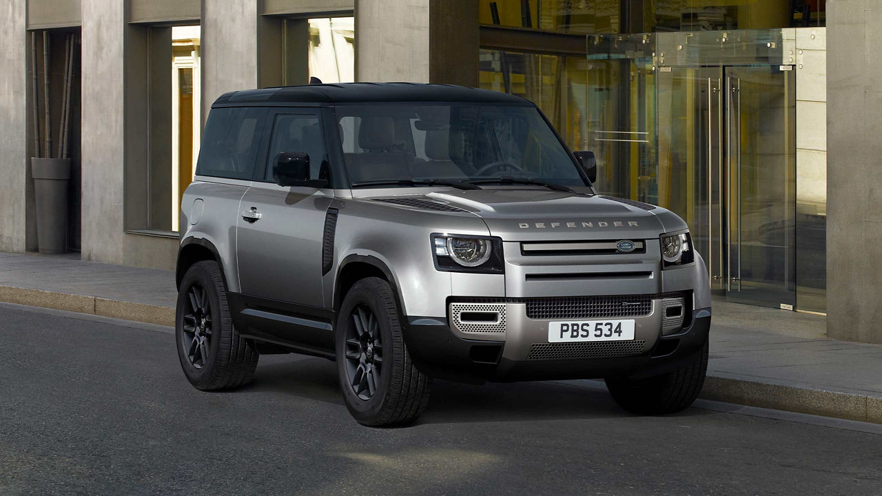 The Defender parked in front of a building