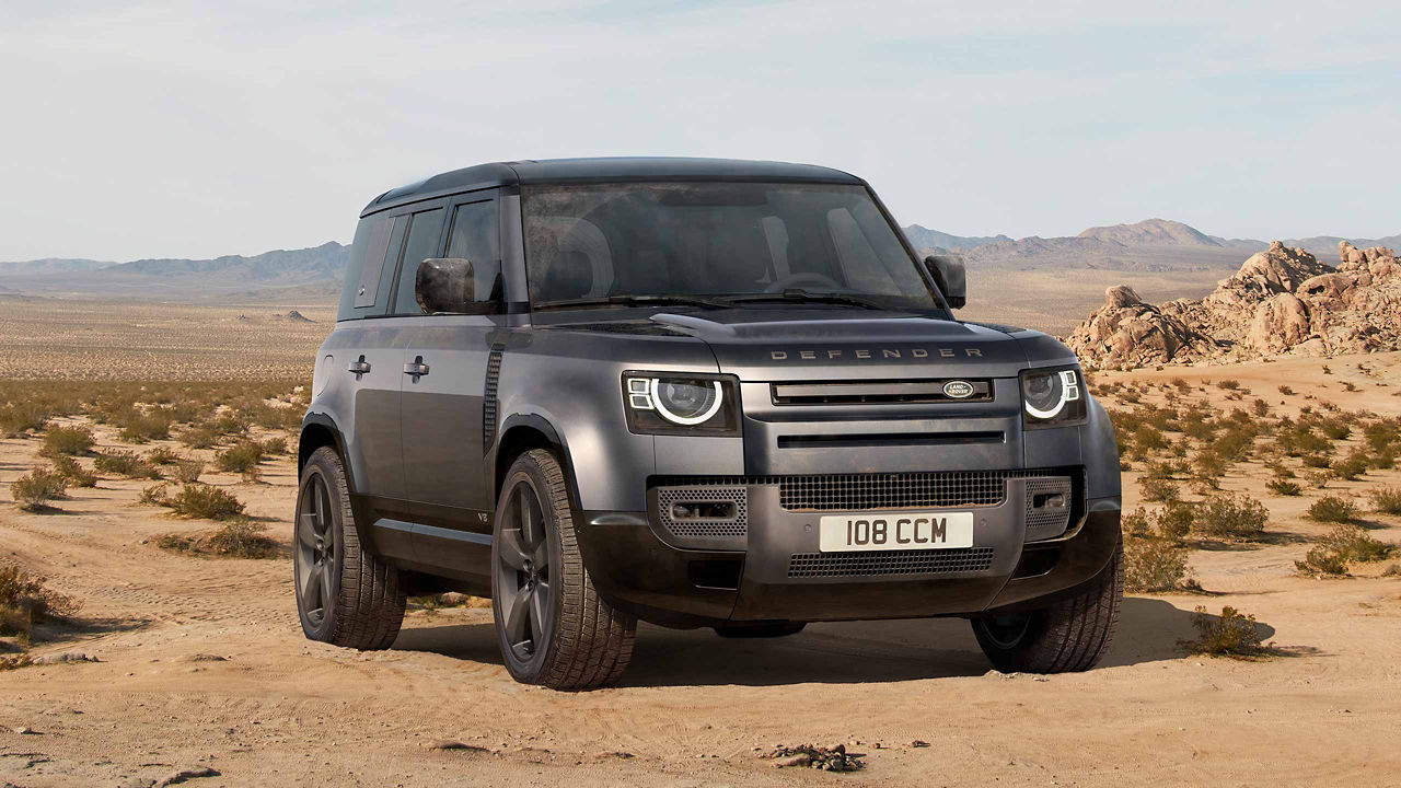 Land Rover Defender black in desert scenery