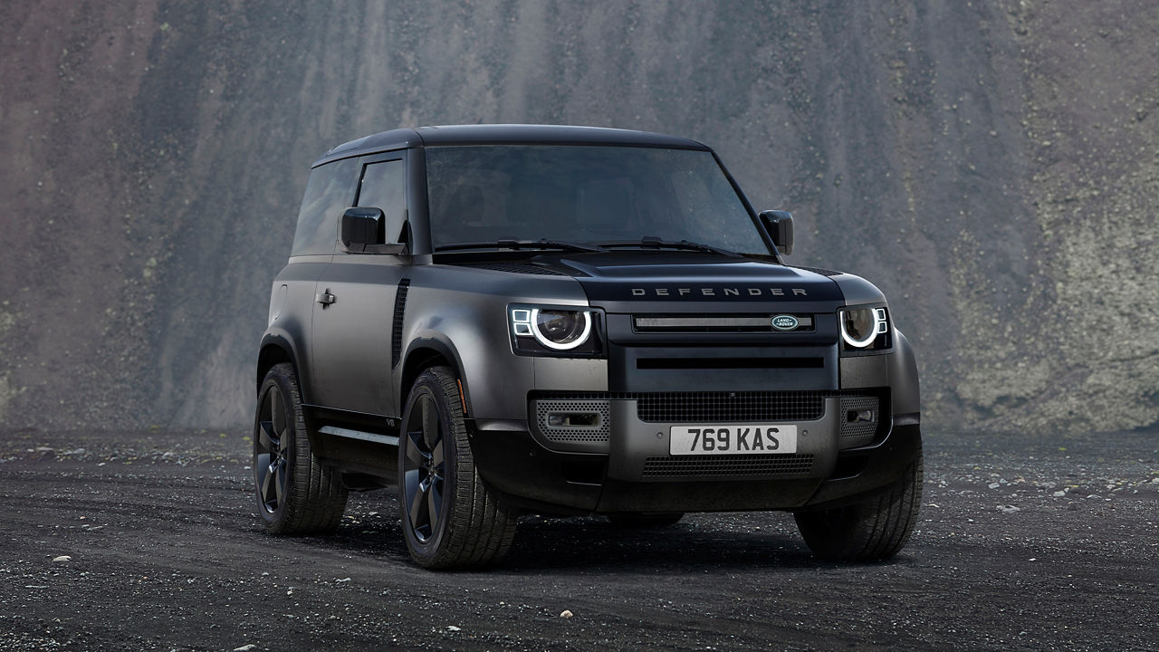 Defender Parked On Stone Road With A Mountain In Background
