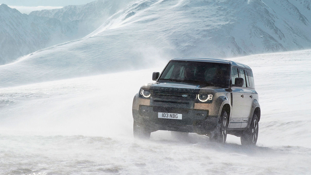 Defender driving on snowy off-road front view