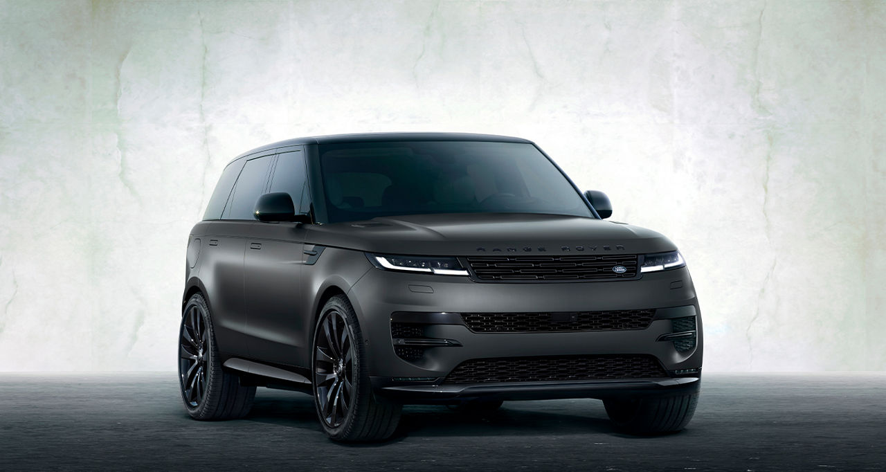 Side view of the Range Rover Sport against a white cement wall