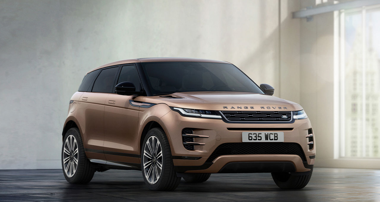 Side view of Range Rover Evoque against a concrete wall and a window