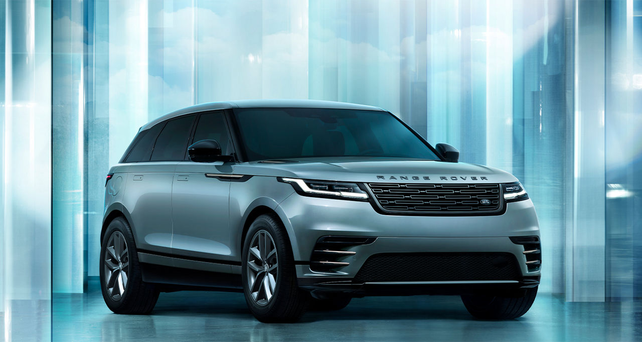 Side view of the Range Rover Velar against a blue cement wall