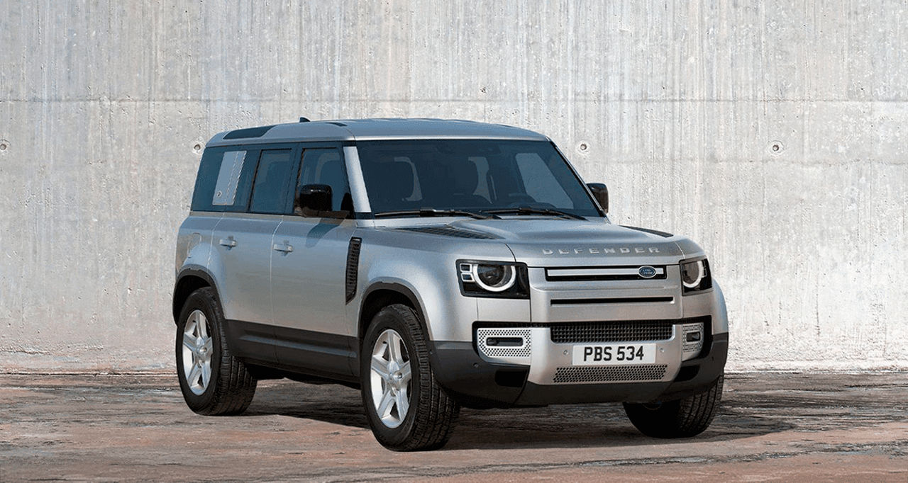 Side view of the Landrover Defender against a white cement wall