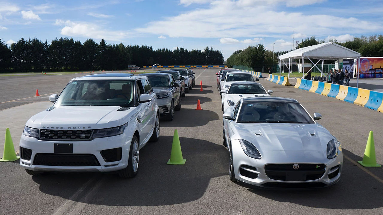 Land  Rover and Jaguar F-Type parked on a Racing Track