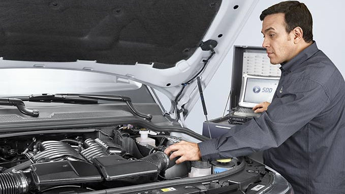 a man servicing a car engine