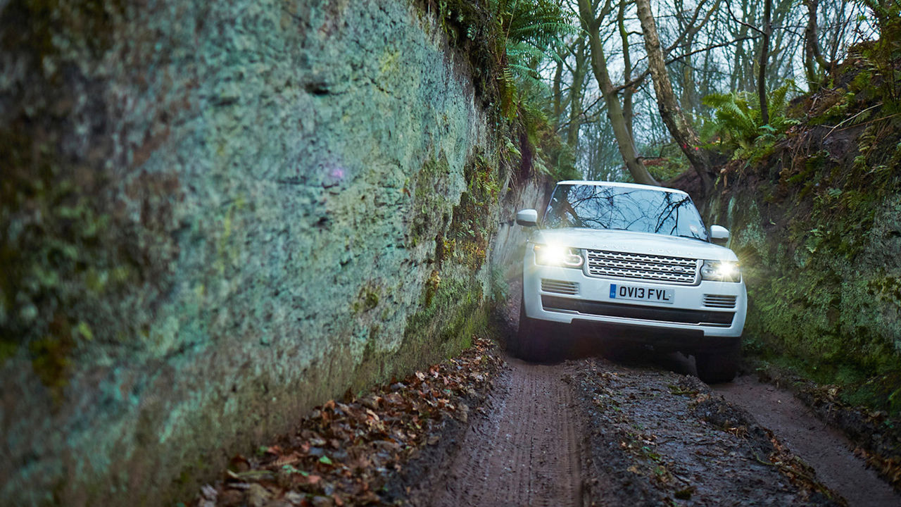 Range Rover driving on muddy path