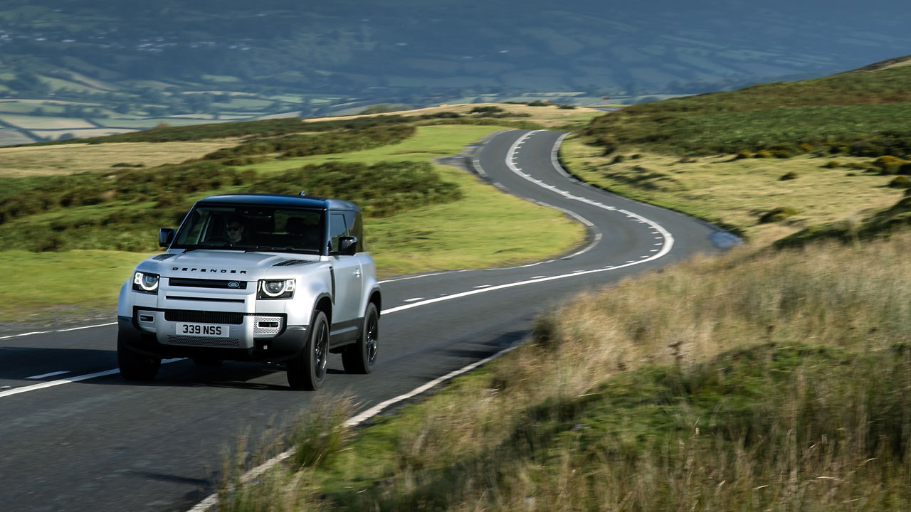 Mountain landscape defender on road