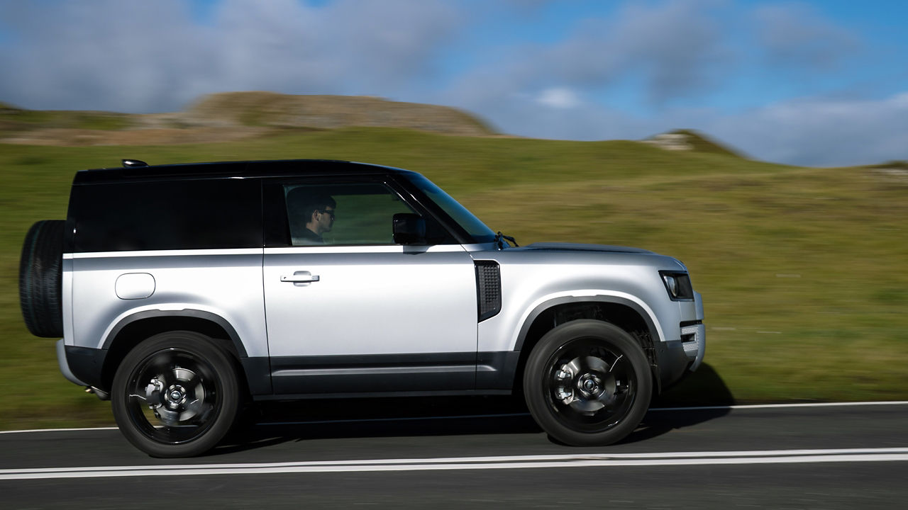 Defender on landscape mountain road