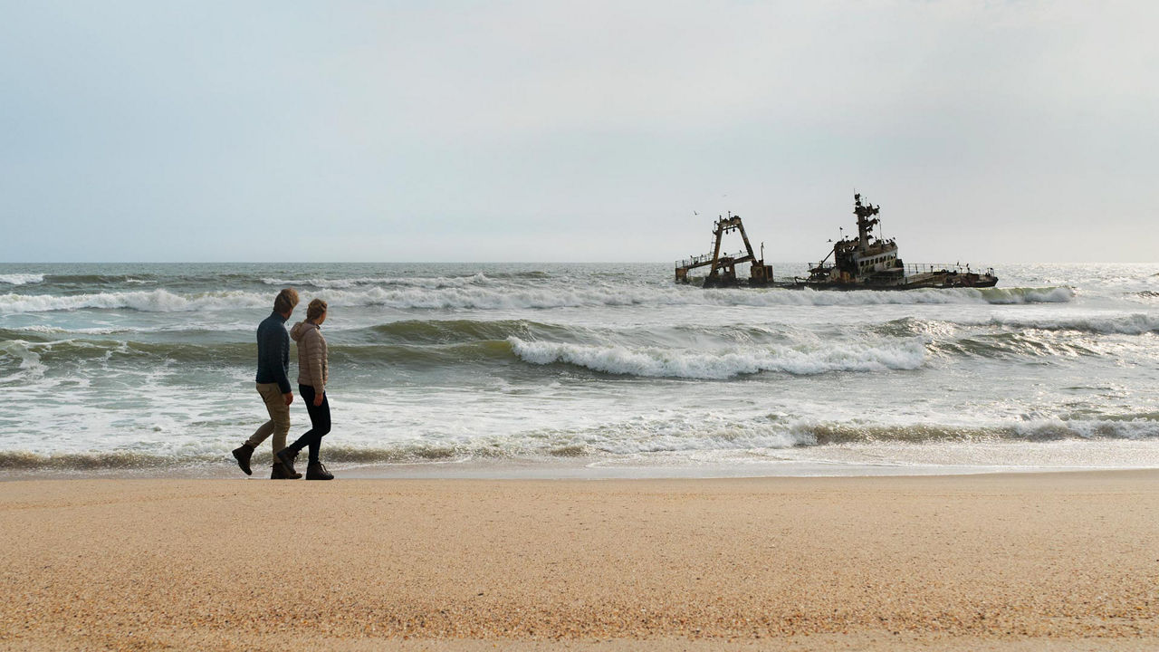 Man and Woman Walking on the Beach