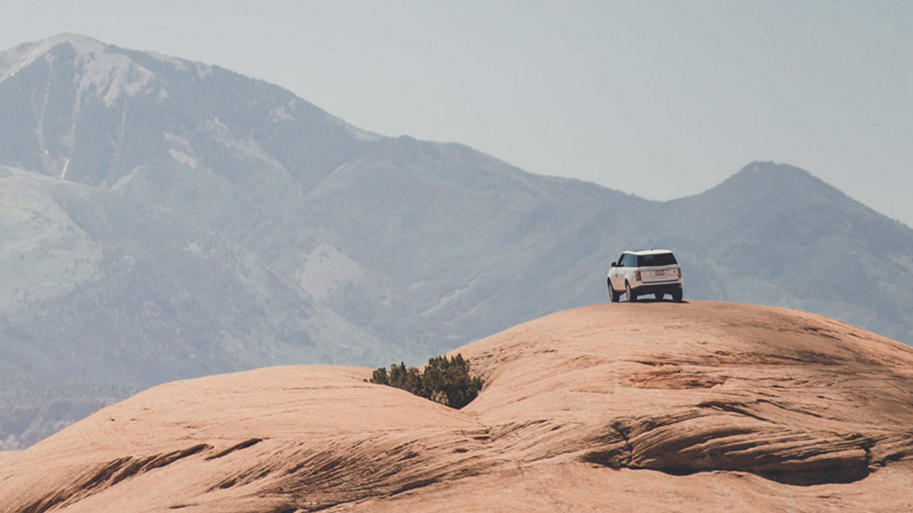 Range Rover parked on a rock 