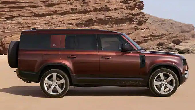 Defender 130 side view in sand