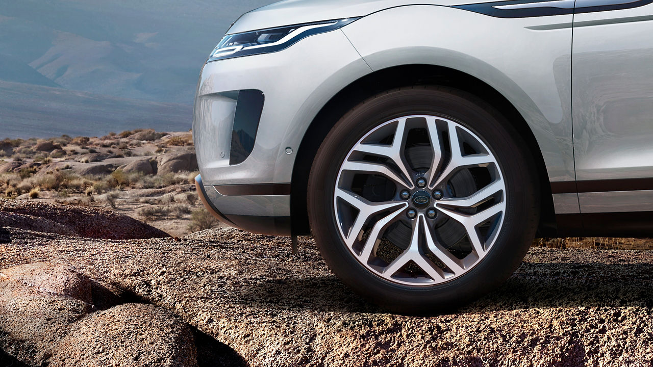 Close-Up Photo Of A Wheel Of A Evoque Car Parked On A Road