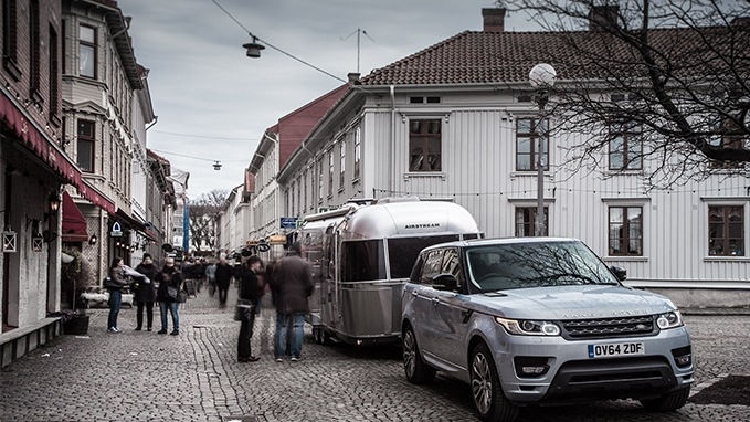 Range Rover with trailer attached parked in the city