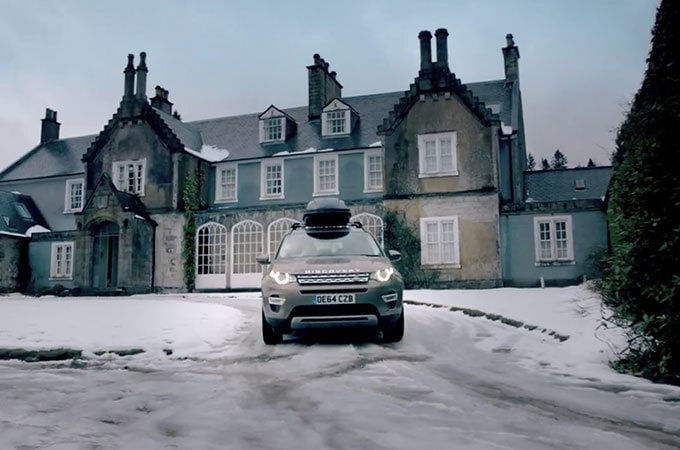 Land Rover Discovery parked outside house 