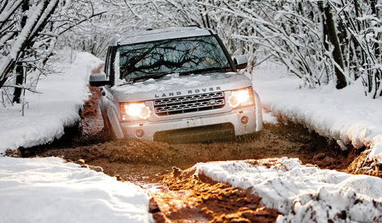 Land Rover driving through snow and mud