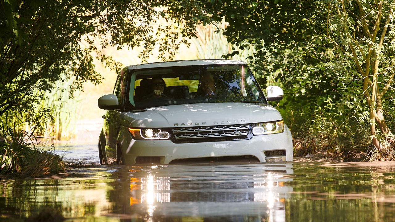 The Range Rover travels across the water on the forest test road