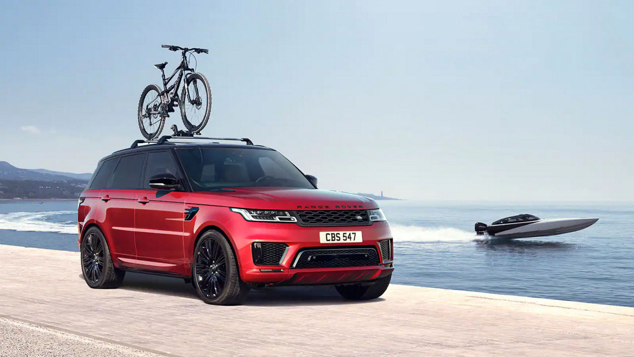 Range Rover Sport (Red) with roof-top bike rack