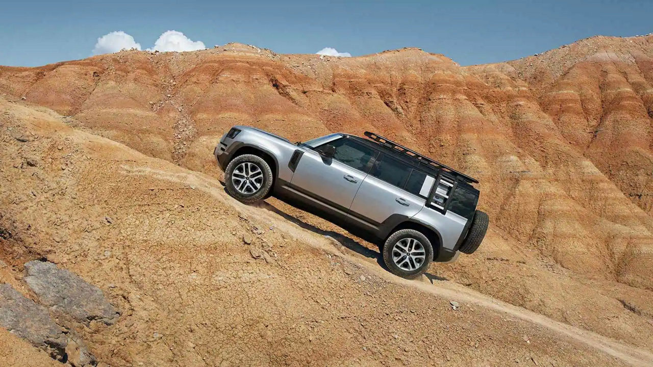 Land Rover Defender 110 driving up steep hill