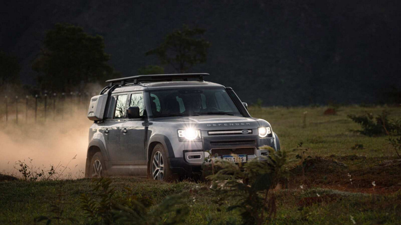Defender driving down a road