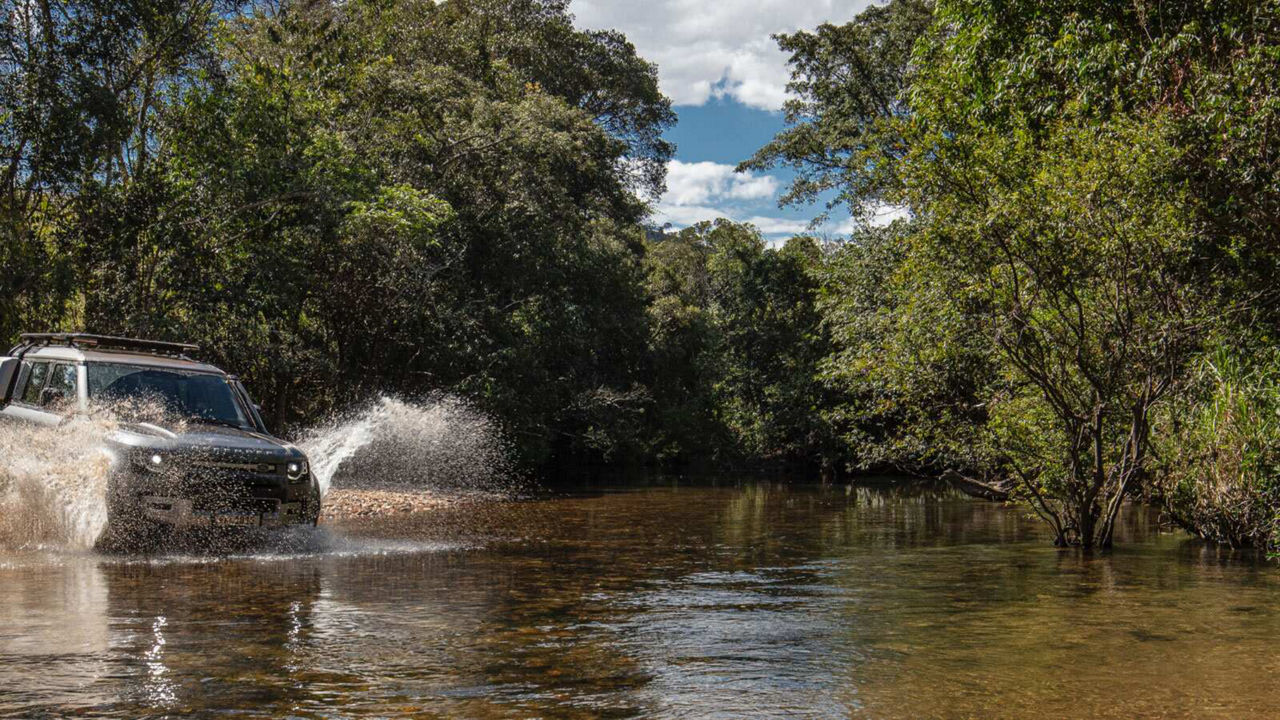 Defender driving through a river