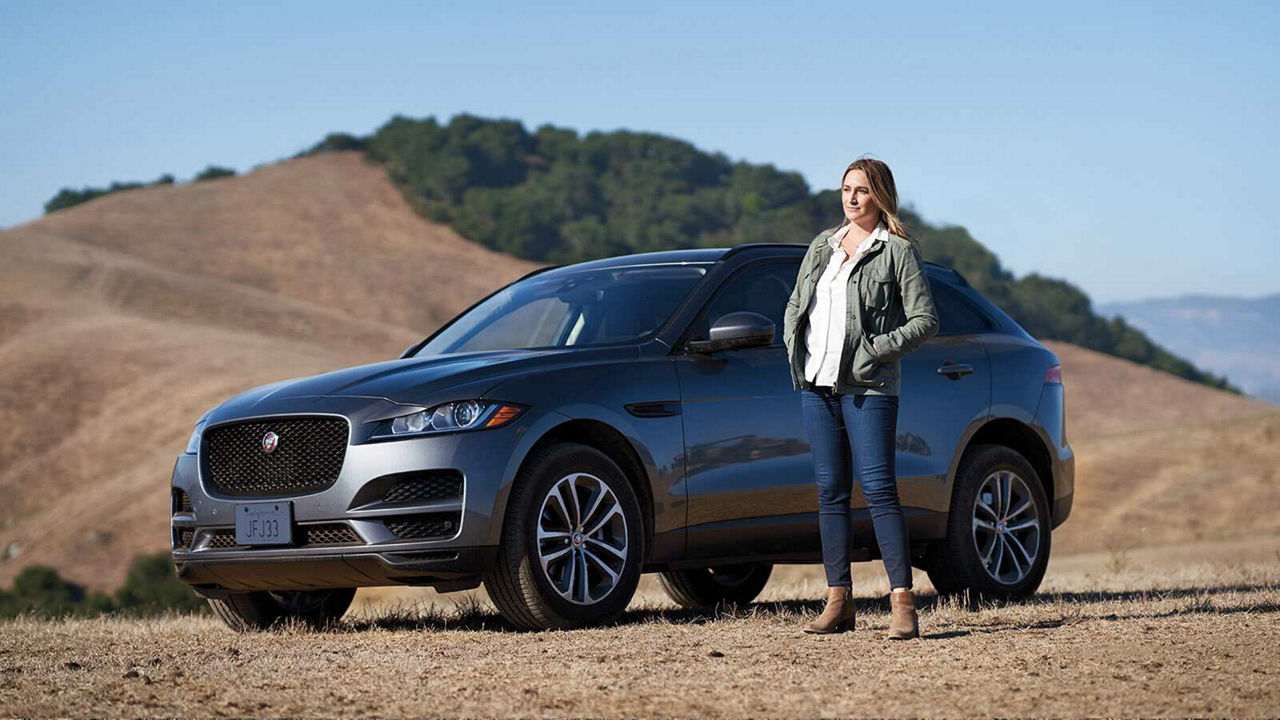 Ashley Avis and the Jaguar F-PACE in a desert setting.