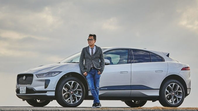 Blue jeans man standing in-front of JAGUAR